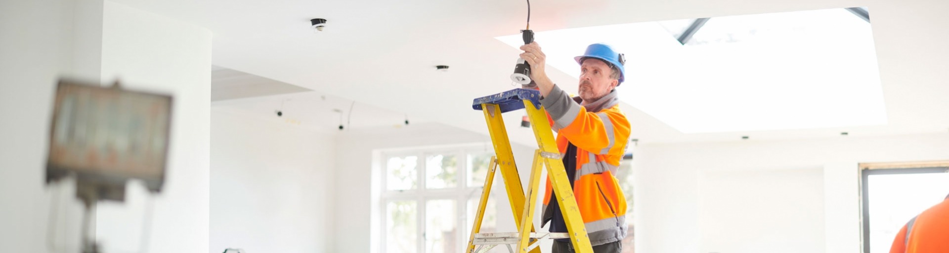 een elektricien is bezig met de bedrading in een huis